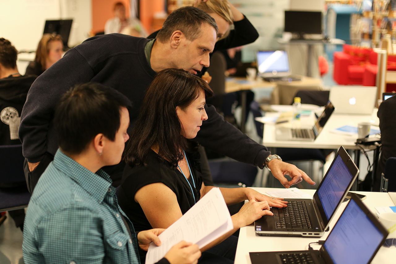 Volunteers working together at a laptop